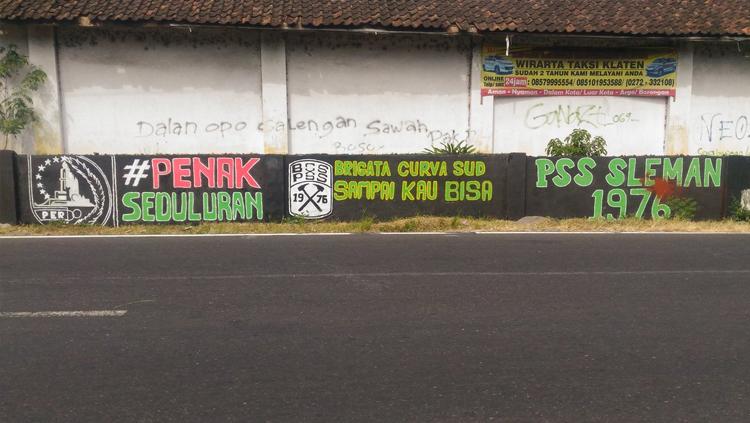 Mural bertuliskan pesan #PenakSeduluran. - INDOSPORT