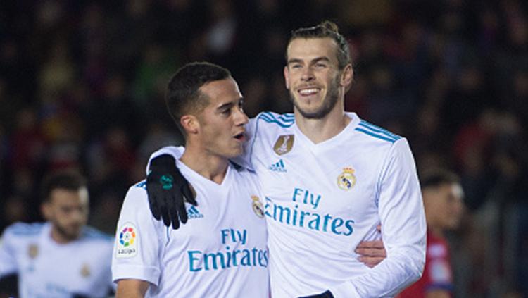 Indosport - Gareth Bale melakukan selebrasi bersama Lucas VÃ¡zquez.
