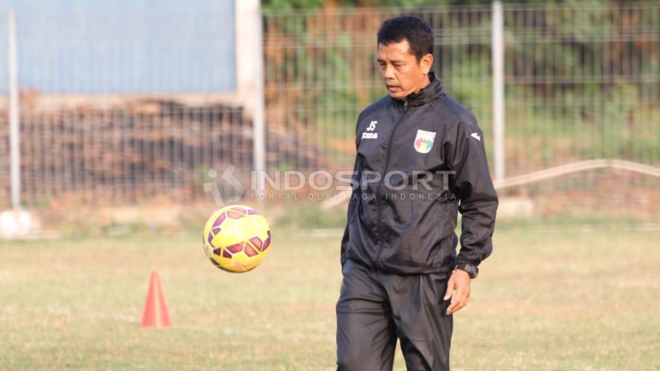Pelatih Mitra Kukar, Jafri Sastra sedang melakukan jugling bola.