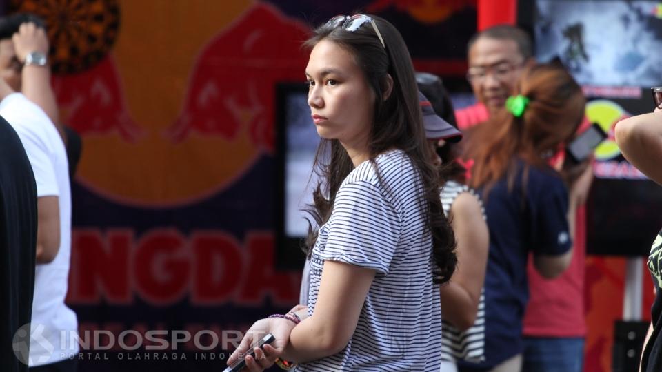 Wanita berpakaian motif garis-garis ini tampak berjalan sendirian.