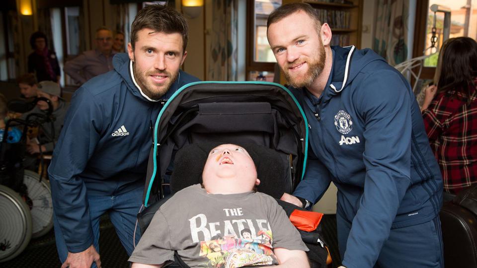 Kapten Manchester United, Wayne Rooney (kanan) bersama Michael Carrick (kiri) berfoto bersama pasien  Rumah Sakit Hospice of St Francis.