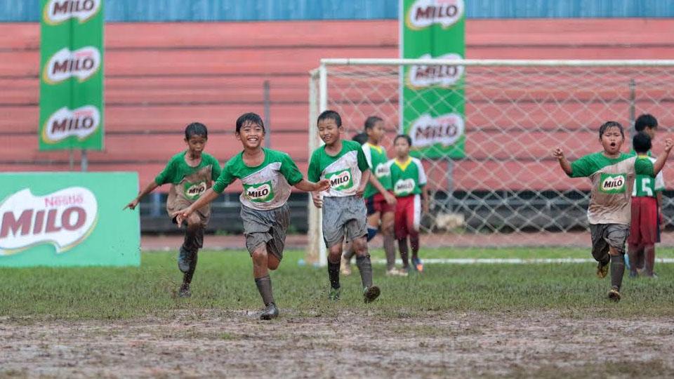 Ekspresi kebahagiaan salah satu peserta MILO Football Championship Jakarta setelah berhasil mencetak gol di GOR Soemantri Brodjonegoro. - INDOSPORT