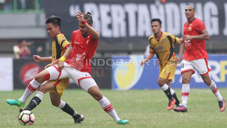 Perebutan bola antara pemain Persija Jakarta melawan Mitra Kukar.