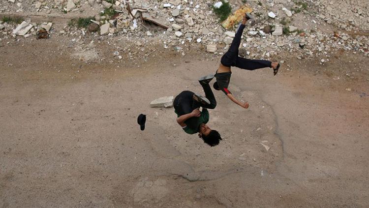 Di tengah-tengah terjadi peperangan dahsyat, pemuda ini lakukan parkour. Copyright: haaretz.com