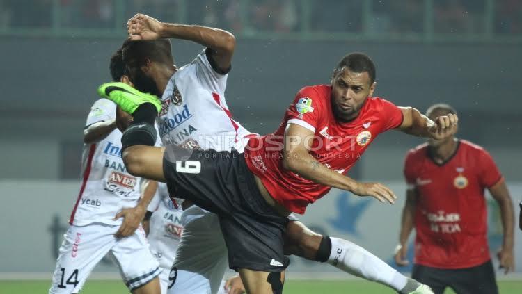 Indosport - Duel antara Luiz Carlos de Junior (Persija Jakarta) dengan pemain belakang Bali United.