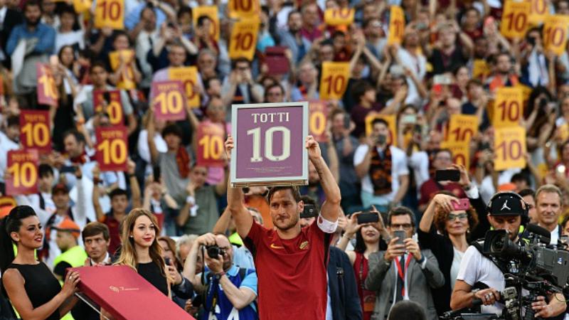 Francesco Totti memegang reklame bertuliskan angka 10. Copyright: VINCENZO PINTO / Staff via Getty Images