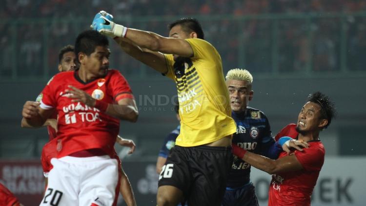 Bambang Pamungkas (kiri) dan kiper Andritany Ardhiyasa (kanan) mecoba menghalau bola yang lahir dari serangan Arema FC.