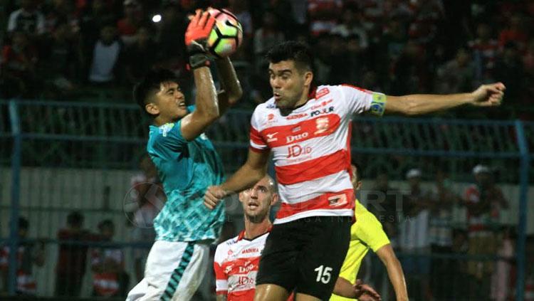 Fabiano Beltrame saat duel udara dengan kiper GU. Copyright: Ian Setiawan/INDOSPORT