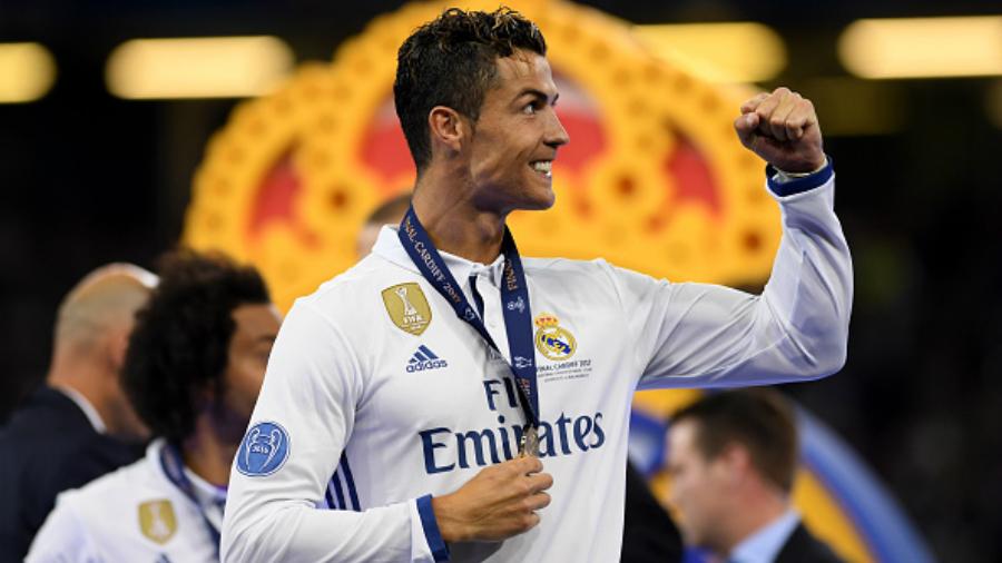 Cristiano Ronaldo berselebrasi pasca menerima medali juara Liga Champions. Copyright: Matthias Hangst / Staff