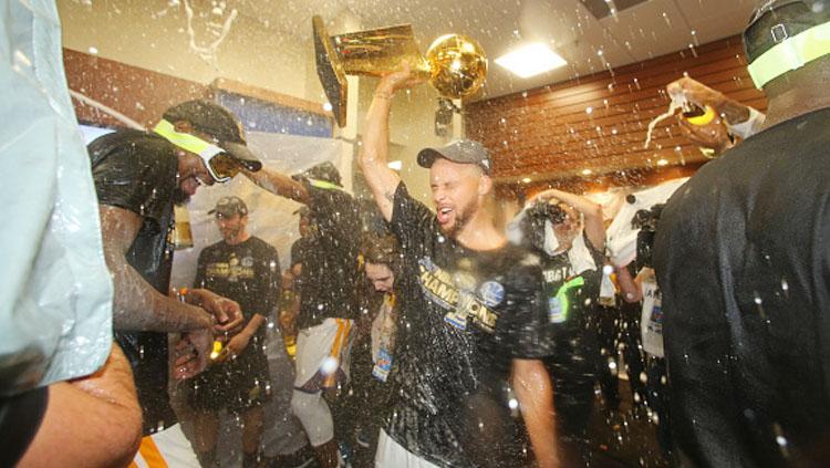 Aksi selebrasi pemain Golden State Warriors di ruang ganti usai juara NBA musim 2016/17. Copyright: INDOSPORT