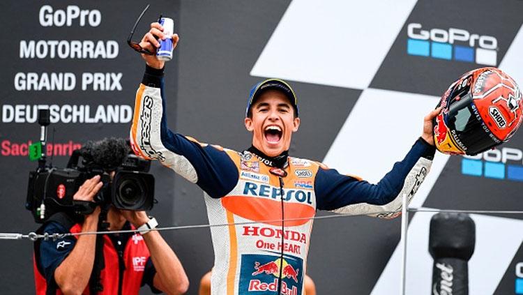 Marc Marquez tengah merayakan kemenangnya di atas podium di GP Jerman. Copyright: INDOSPORT