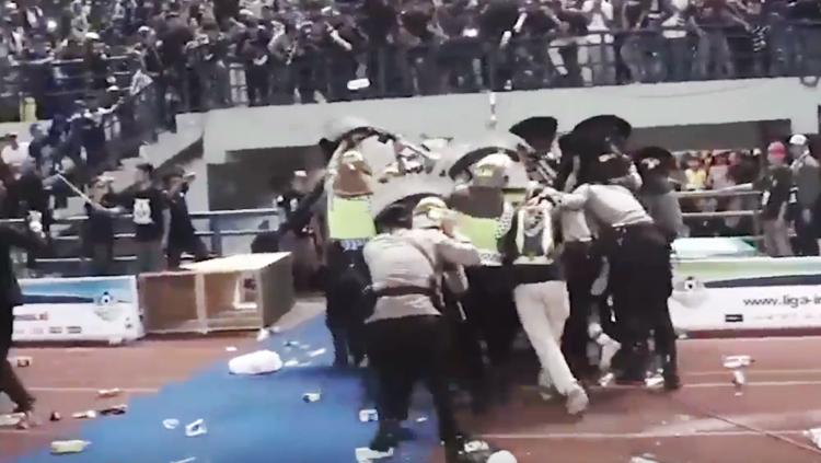 Pemain Persija Jakarta harus diamankan dengan penjagaan ketat polisi akibat aksi pelemparan botol oleh oknum suporter Persib Bandung atau Bobotoh. Copyright: internet