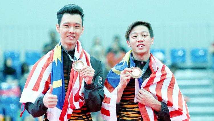 Jeremiah Loo Phay Xing (kanan) bersama Tan Fu Jie berjaya memenangi pingat emas dalam acara gimnastik artistik lelaki. Copyright: Twitter@bharianmy