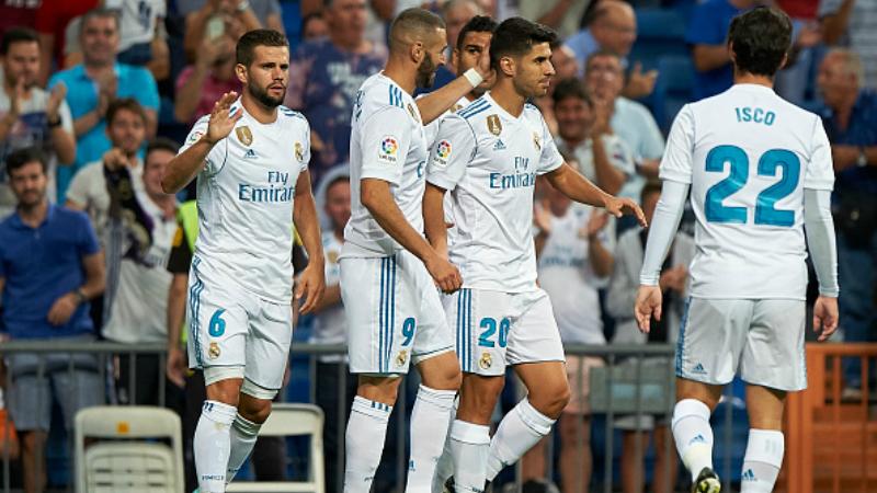 Marco Asensio merayakan golnya yang pertama bersama rekan-rekannya. - INDOSPORT