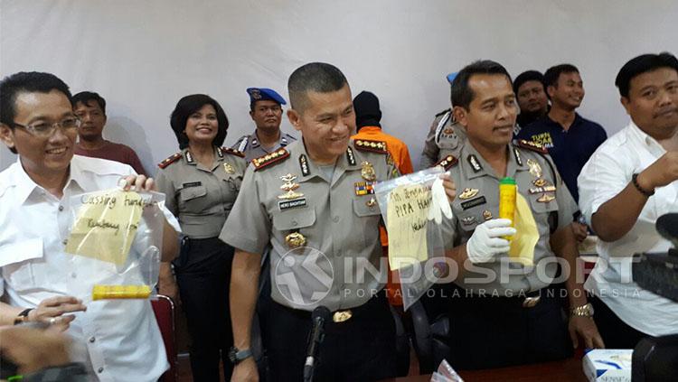 Polresta Bekasi menunjukkan barang bukti dari tersangka pelaku insiden flare maut. Copyright: Indosport/Muhammad Adiyaksa