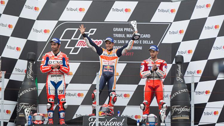 Danilo Petrucci, Andrea Dovizioso, dan Marc Marquez selebrasi di atas podium.