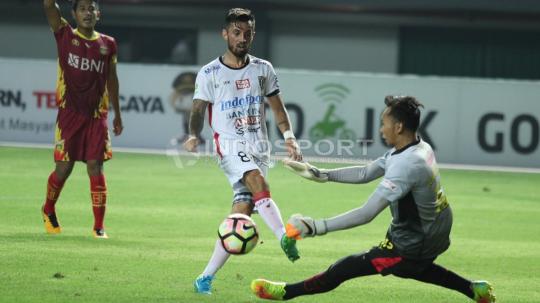 Tendangan pemain Bali United, Stefano Lilipaly (tengah) digagalkan kiper Bhayangkara FC, Awan Setho (kanan). Copyright: INDOSPORT/Herry Ibrahim