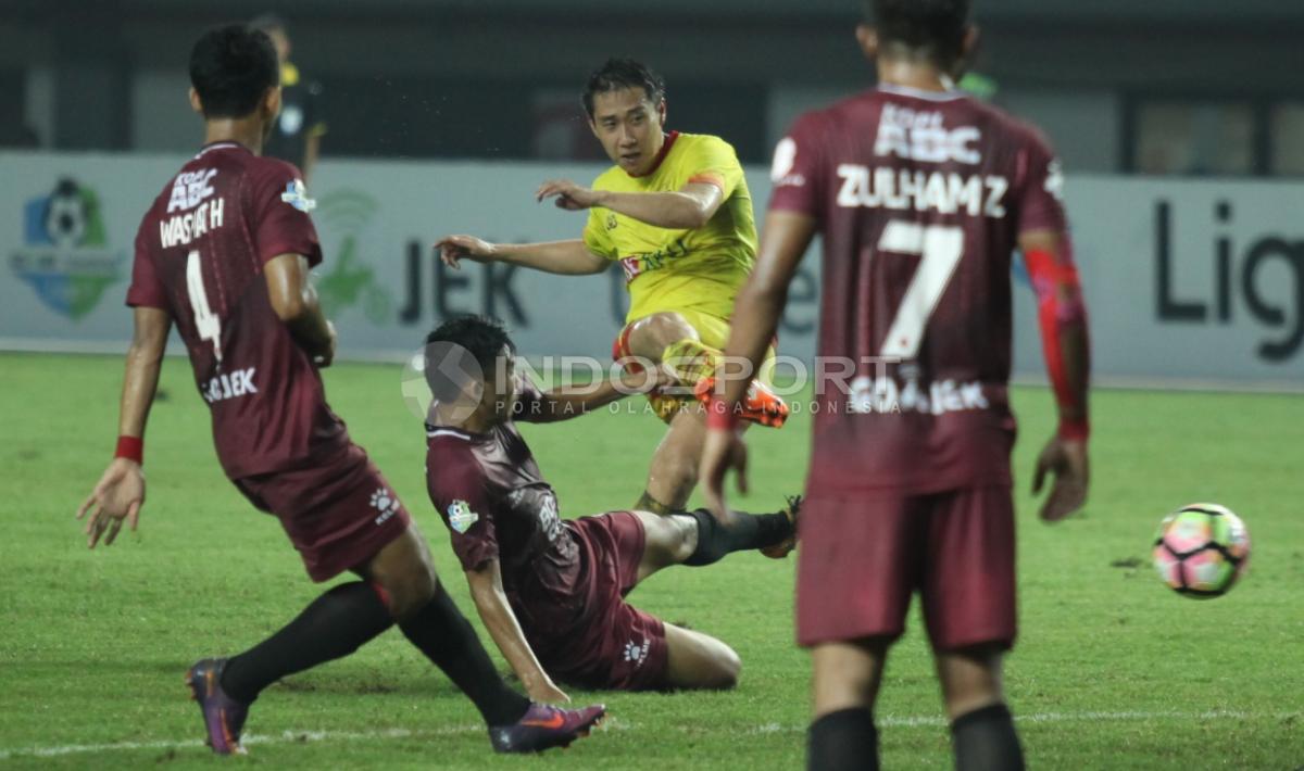 Pemain Bhayangkara FC, Lee Yujun (tengah) melakukan tendangaj ke gawang PSM Makassar.