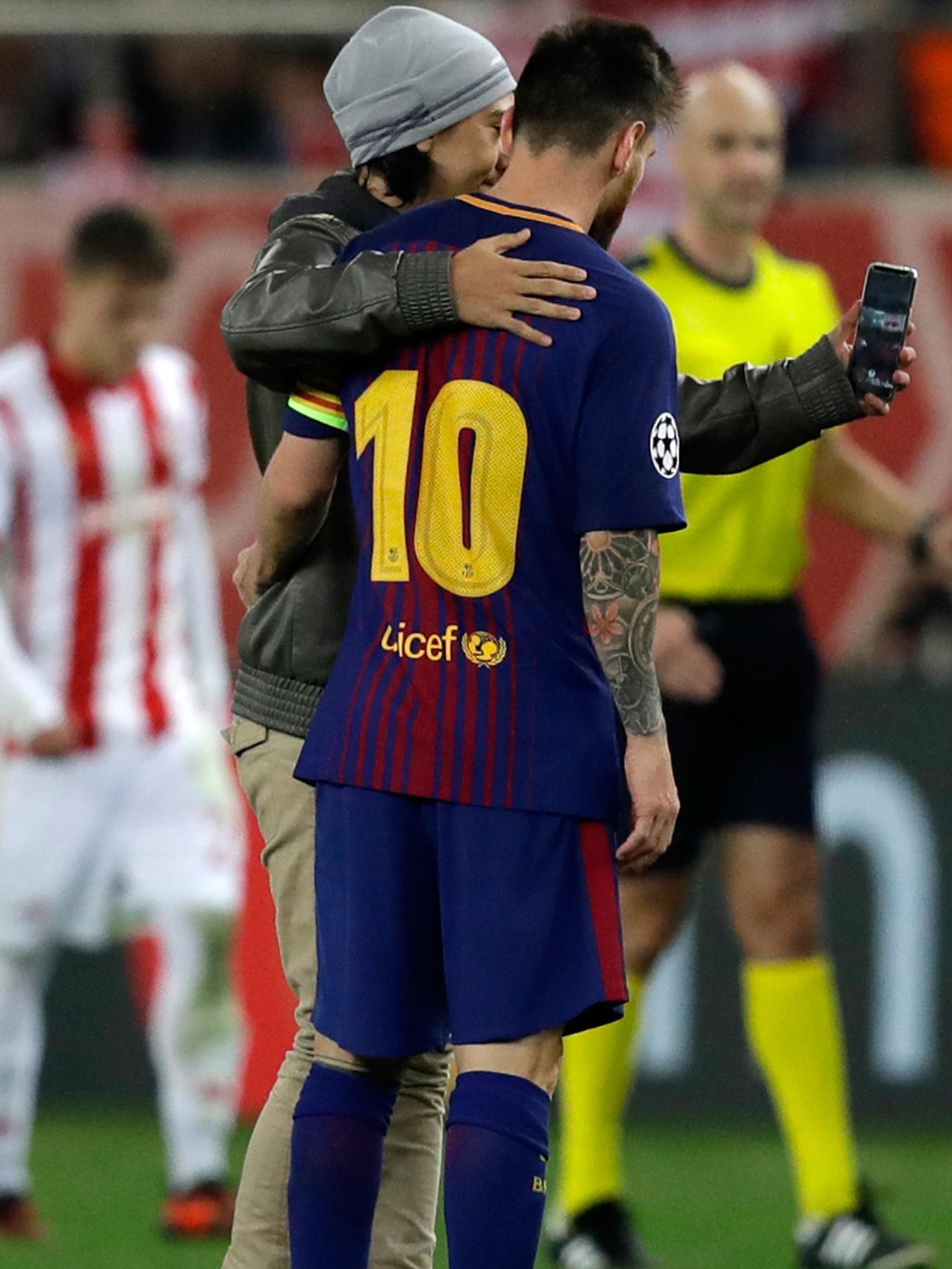 Lionel Messi diminta untuk selfie oleh fans di tengah pertandingan antara Olympiakos kontra Barcelona. Copyright: AP