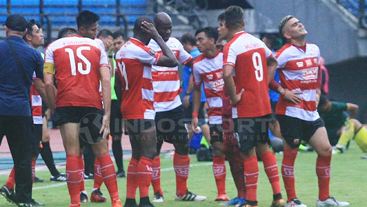 OK John saat diskusi dengan pemain Madura United dalam water break. Copyright: Ian Setiawan/INDOSPORT