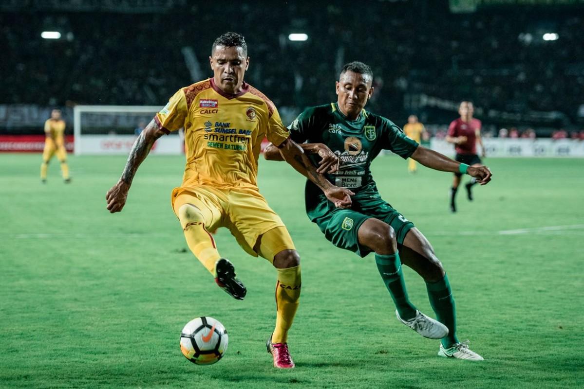 Aksi bek Persebaya, M. Syaifudin, saat menghalau pemain Sriwijaya FC.