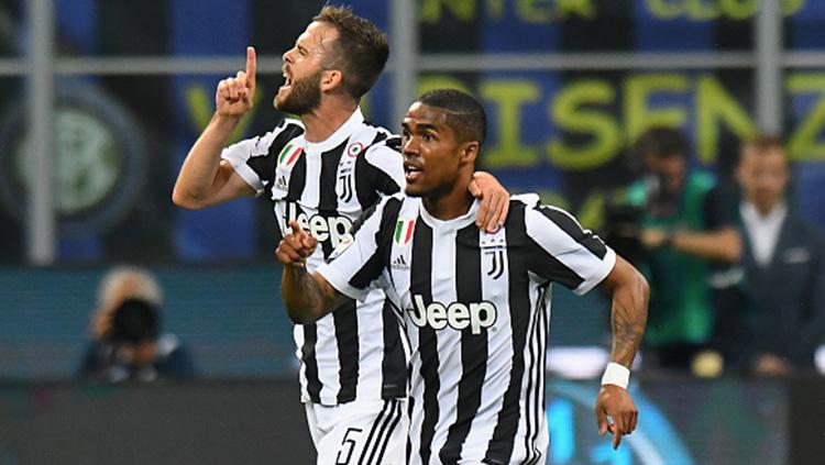 Douglas Costa berselebrasi usai membobol gawang Inter Milan. Copyright: INDOSPORT