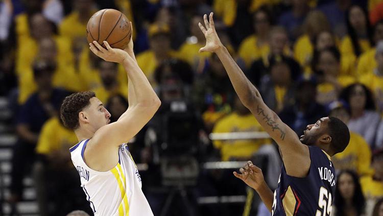 Bola tembakan Klay Thompson (kiri) berusaha dihalau pemain New Orleans Pelicans, E'Twaun Moore.