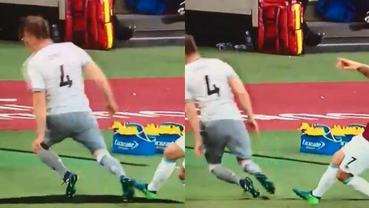 Phil Jones tersandung rumput pinggir lapangan.