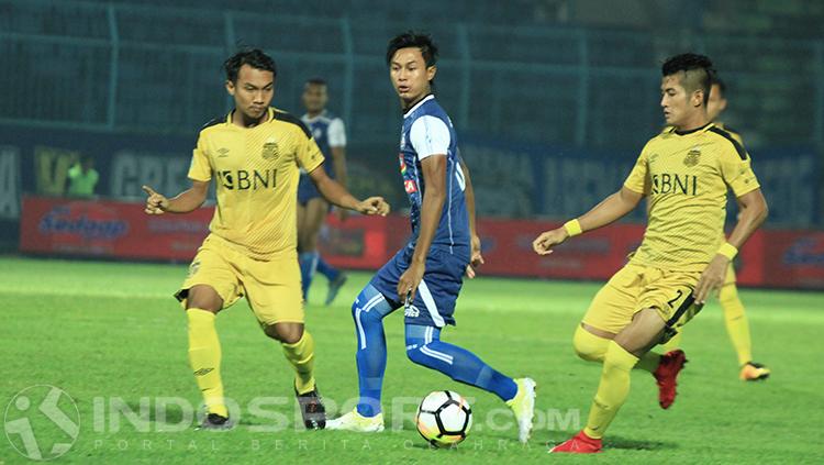 Johan Al Farisi saat dibayangi dua pemain Bhayangkara FC Copyright: INDOSPORT/Ian Setiawan