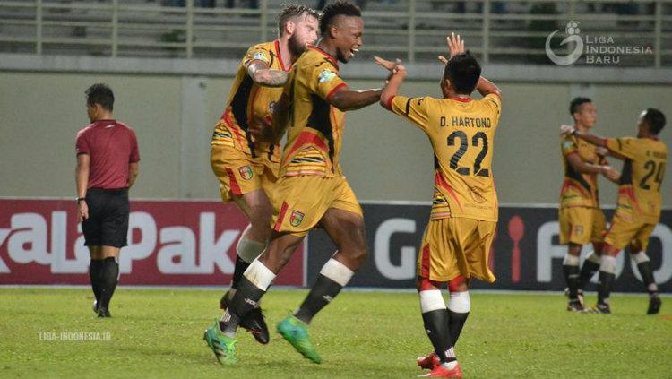 Bek Mitra Kukar Mauricio Aparecido Leal merayakan gol.