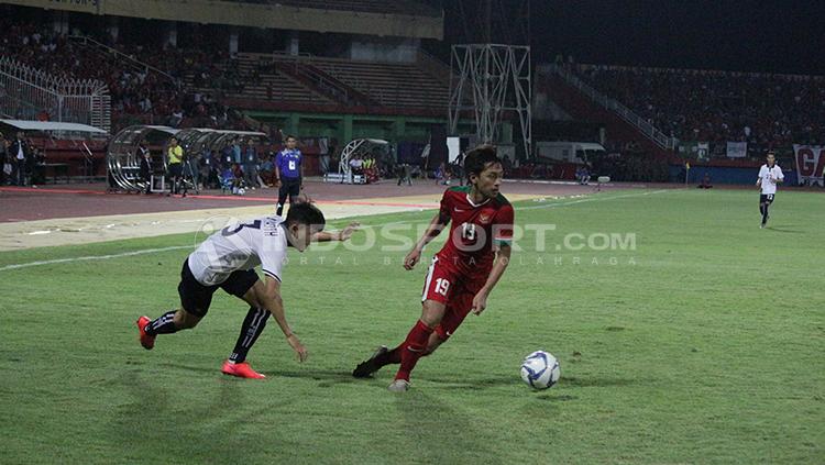 Pemain Timnas Indonesia U-19, Hanis Saghara Putra saat berhasil mengecoh pemain Laos. - INDOSPORT