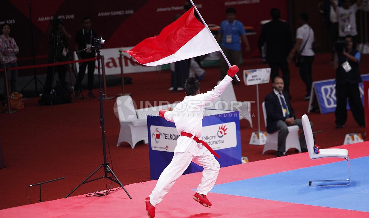 Selebrasi atlet Karate Indonesia, Rifki Ardian Arrosyid berlari dengan membawa bendera Merah Putih usai memastikan gelar juara.