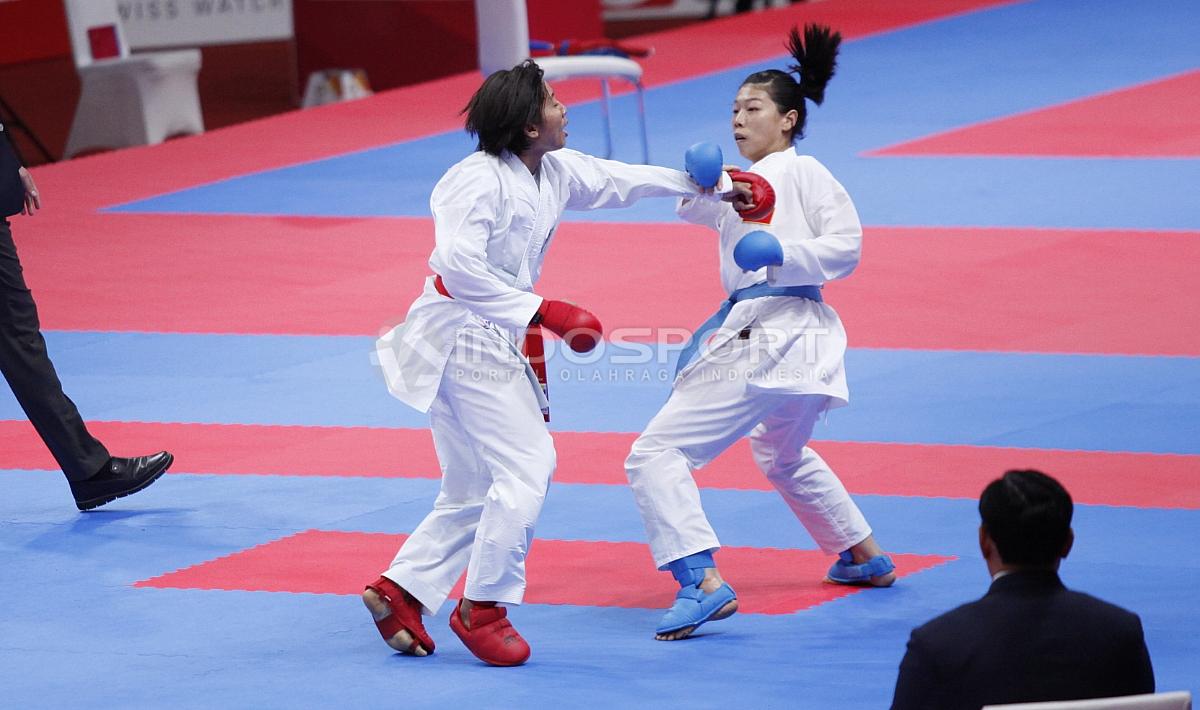 Karateka Indonesia, Cok Istri Agung Sanistyarani (sabuk merah) melawan karateka China, Jiamei Ding pada perebutan medali perunggu kelas Putri -55kg di Plenary Hall JCC, Jakarta, Minggu (26/08/18).
