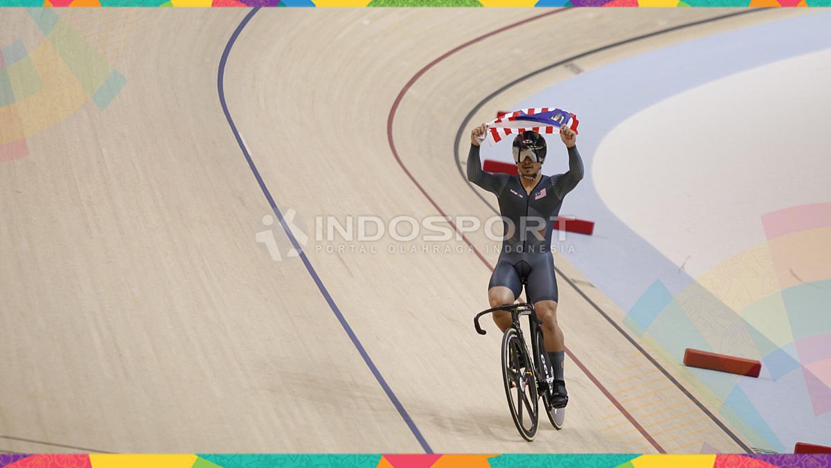 Pebalap sepeda Malaysia, Awang Mohd Azizulhasni membawa bendera negaranya usai menjuarai kelas Sprin Putra di Jakarta International Velodrome, Kamis (30/08/18). Awang berhasil meraih medali emas di nomer ini.