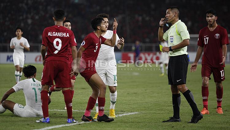 Pemain dari Qatar U-19 melayangkan protes kepada wasit.