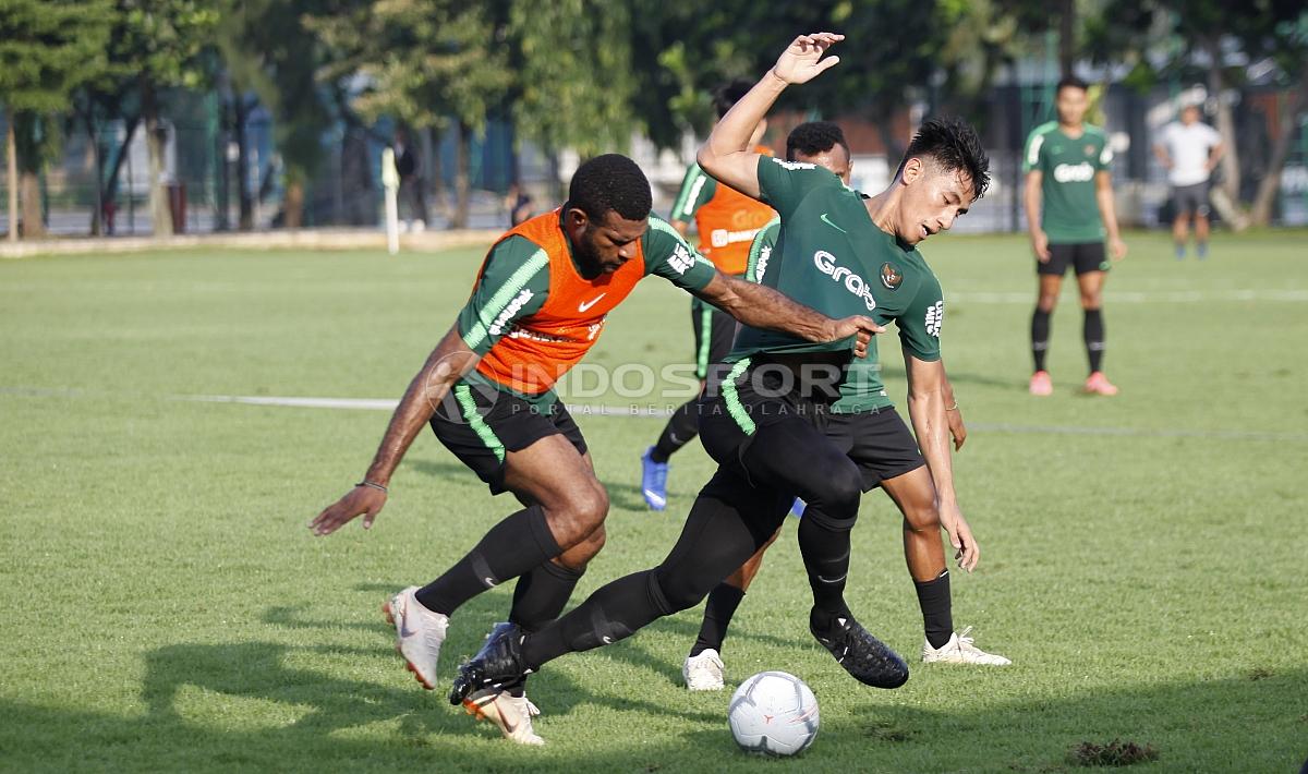 Hanif Sjahbani (tengah) berebut bola dengan Marinus Wanewar.