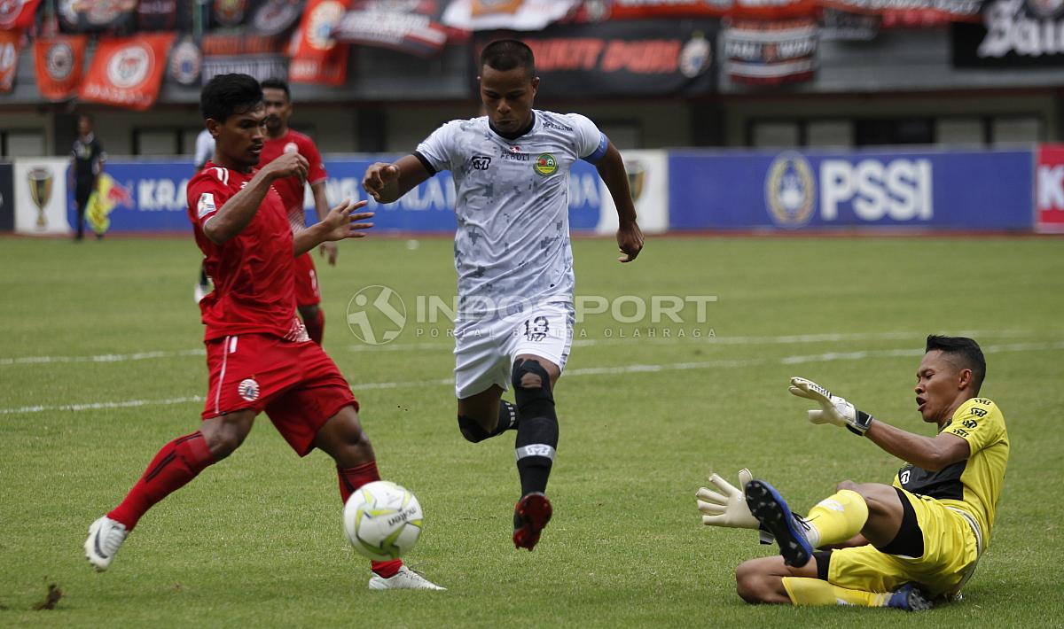 Manahati Lestusen (tengah) mencoba menghalau peluang pemain Persija di depan gawang PS Tira yang dikawal Syahrul Trisna (kanan).