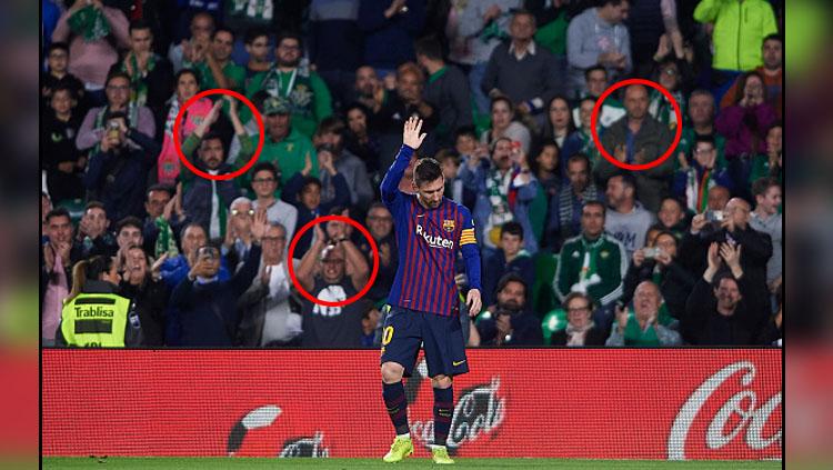 Pemain megabintang Barcelona, Lionel Messi mendapat standing applause dari fans Real Betis. Copyright: INDOSPORT