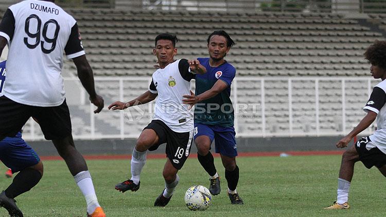 Pemain Bhayangkara FC, TM Ichsan (tengah) saat mencoba melewati hadangan pemain PPLM Ragunan dalam laga uji coba di Stadion Madya, Senayan, Selasa (26/03/19).