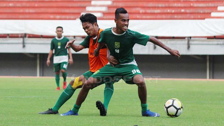 M Hidayat berebut bola dengan Alwi Slamat saat latihan menjelang laga Liga 1 2020 di Stadion GBT, Minggu (21/4/19). Fitra Herdian//INDOSPORT - INDOSPORT