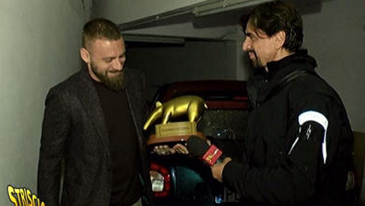 Daniele de Rossi mendapat sebuah trofi berbentuk tapir. Copyright: Sportmediaset