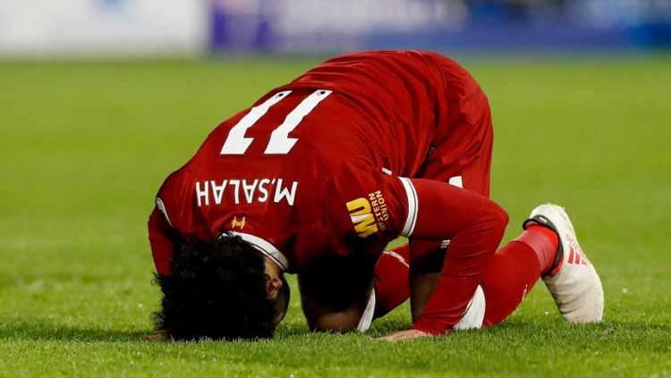 Mohamed Salah sujud usai Liverpool kalahkan Sevila di Liga Champions. Foto: bolagpsport.com - INDOSPORT