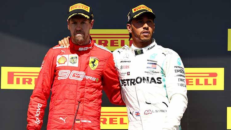 Lewis Hamilton mengajak Sebastian Vettel untuk berdiri di podium pertama F1 GP Kanada 2019. Mark Thompson/Getty Images.