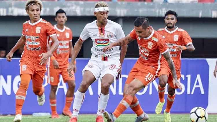 Bruno Matos berusaha menghalangi salah satu pemain Borneo FC. Copyright: Media Persija