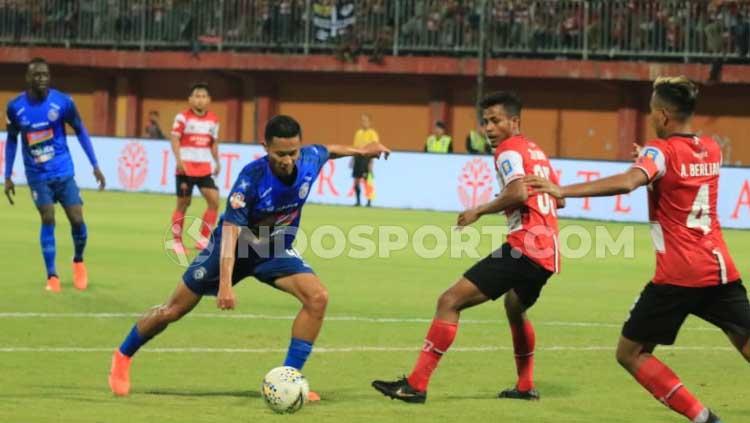 Bintang Arema FC, Dendi Santoso melewati hadangan pemain Madura United. Copyright: Ian Setiawan/INDOSPORT