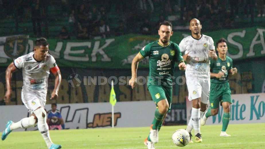 Pemain Persebaya, Damian Lizio lolos dari kawalan pemain Tira-Persikabo, Manahati Lestusen, Minggu (21/07/19). Foto: Fitra Herdian/INDOSPORT Copyright: Fitra Herdian/INDOSPORT