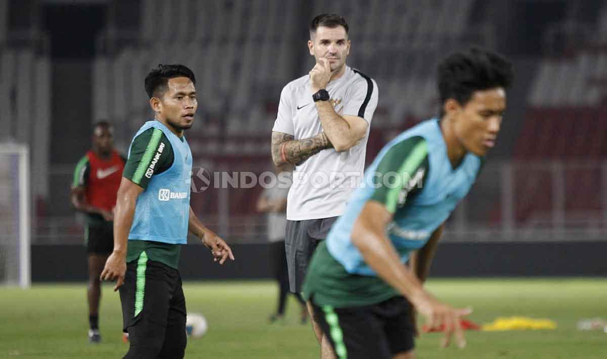 Simon McMenemy tangah memperhatikan perkembangan anak asuhnya jalani latihan, termasuk Andhika Wijaya.