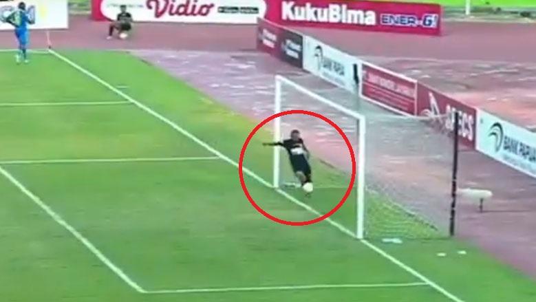 Ricardo Salampessy menyapu sepakan Ezechiel Ndouassel di laga Persipura vs Persib, Senin (23/09/19).