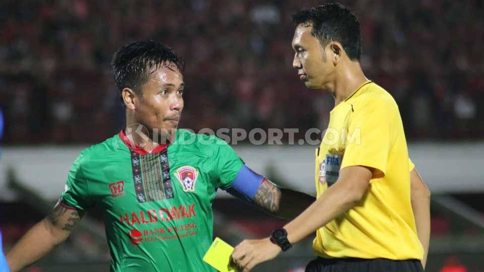 Kapten Kalteng Putra, Gede Sukadana saat berdiskusi dengan wasit Yudi Nurcahya asal Jawa Barat. Copyright: Nofik Lukman Hakim/INDOSPORT