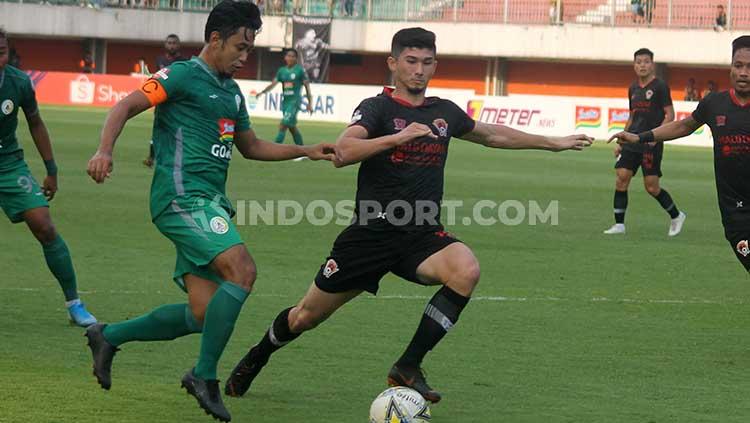 Bek Kalteng Putra, Kevin Gomes (kanan) berusaha mengadang bek PSS Sleman, Bagus Nirwanto dalam laga Shopee Liga 1 di Stadion Maguwoharjo, Jumat (18/10/19). Copyright: Ronald Seger/INDOSPORT